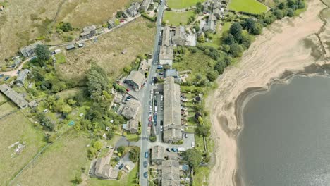 Aerial-footage-of-a-industrial-rural-village-town-with-old-mill-and-chimney-stack-surrounded-by-fields