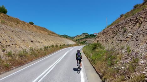 biking on rural hills through beautiful landscape road in scenic albanian village, sport and passion combined