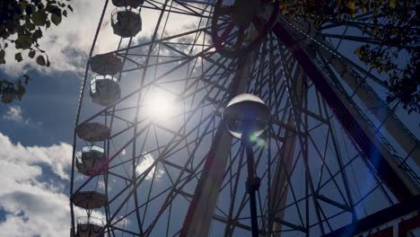 static shot of a ferris wheel slowly turning on a bright summers day