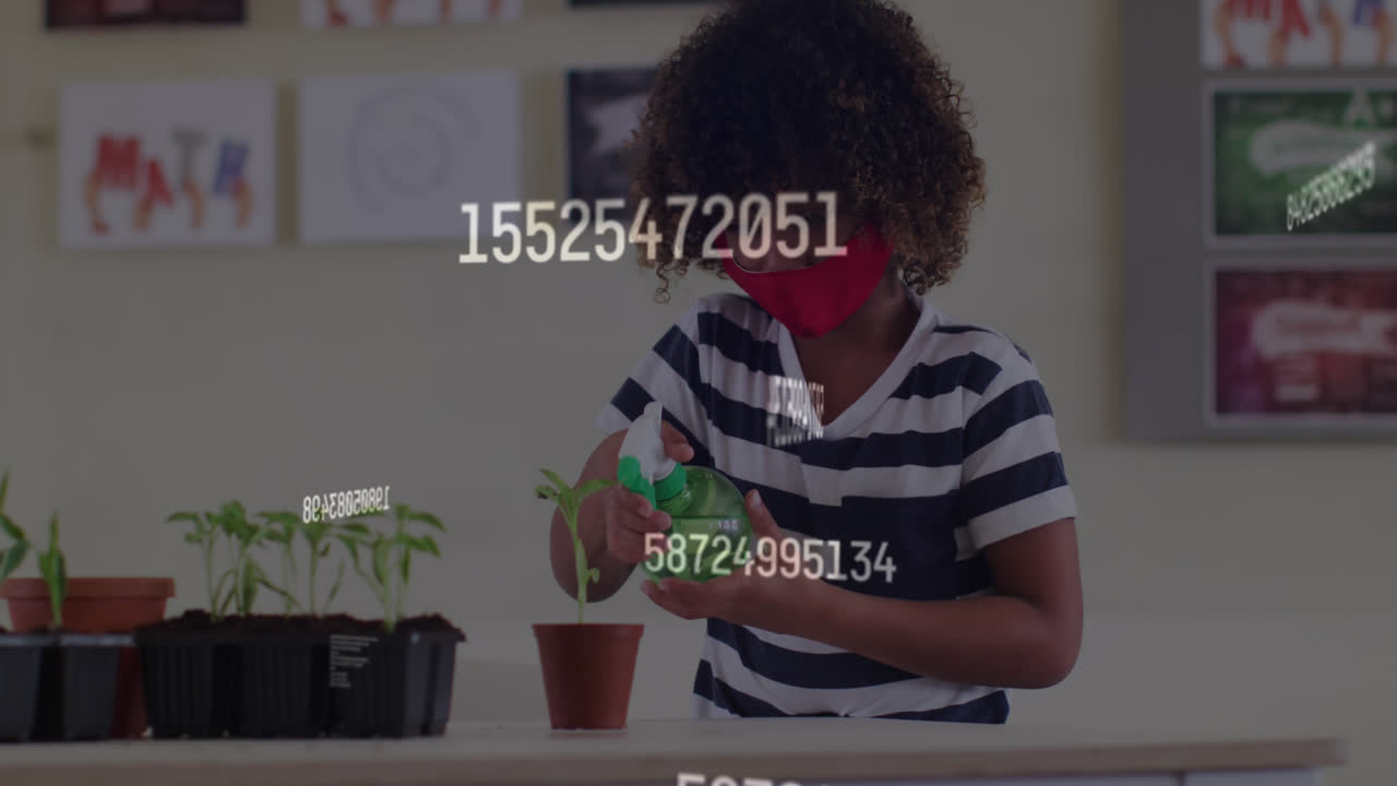 Animation of rising numbers and schoolchild in class wearing face mask watering plant