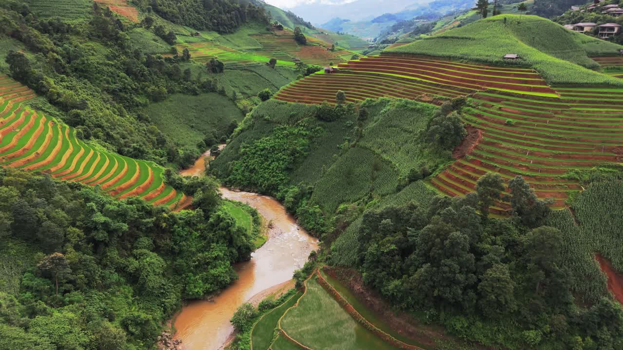 Lush Green Rice Terraces and Winding River in a Mountain Valley