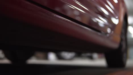 Man-getting-into-car-on-drivers-side.-Closeup-view-from-below,-legs-in-boots.