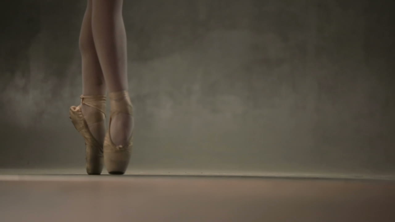 Girl Ballerina Posing In Studio. Young incredibly beautiful girl ballerina posing and dancing in a black studio