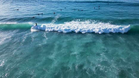 surfista en tabla de surf montar olas perfectas en el mar azul en verano