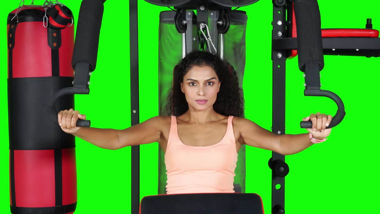 Asian woman exercising on fitness machine