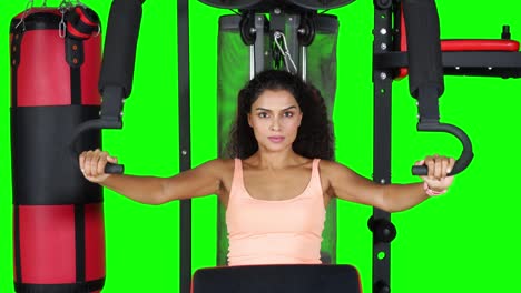 asian woman exercising on fitness machine