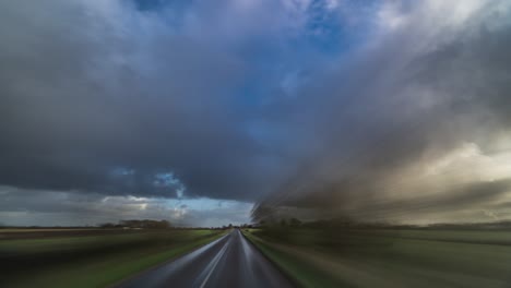 Speeded-up-drive-through-rural-Denmark,-shooting-forth-the-trees-and-farm-fields