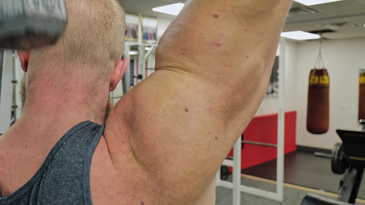 Strong bodybuilder strength workout in sport club