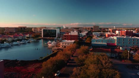 A-drone-shot-starting-over-small-harbor-Main-Street-panning-to-reveal-the-oceant