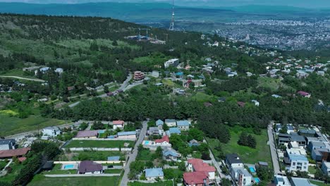drone shot for the nature side of tbilisi with a lot of beautifull green trees and clear sky