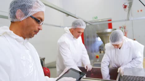 butcher using digital tablet