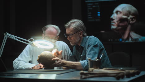 scientists examining a skull and 3d model of a human head in a laboratory