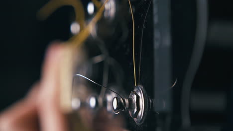 blurry person hands perform barre chords on guitar closeup