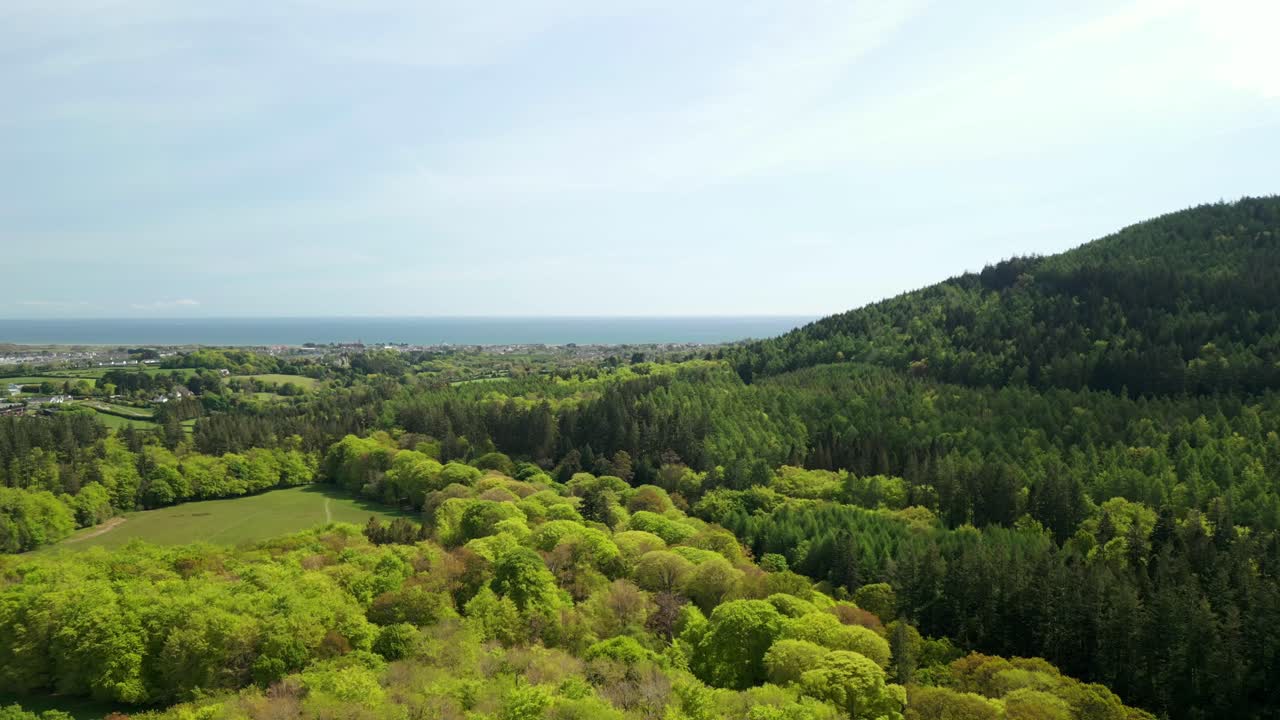Advancing aerial video of the Mourne Mountains and Slieve Donard in Newcastle, County Down in Northern Ireland, UK on a sunny day. Filmed in 4K, 60fps and with Rec709 Color.