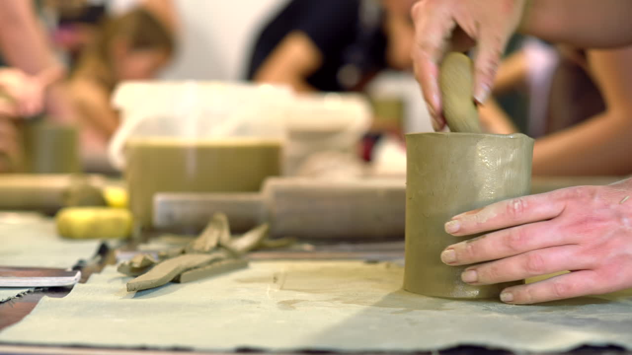 Students modelling clay into cups