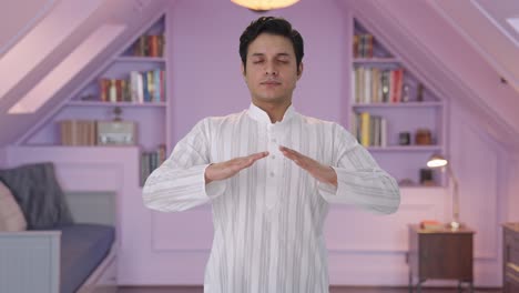 indian man doing breathe in breathe out exercise