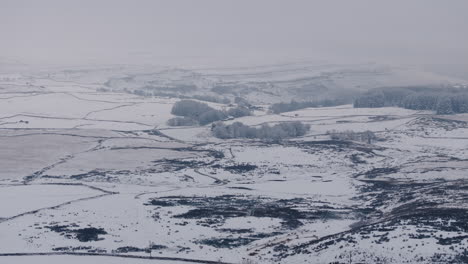 establishing aerial drone shot of snowy yorkshire dales landscape uk