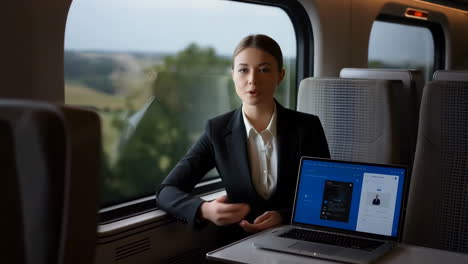 professional woman working on laptop aboard a train