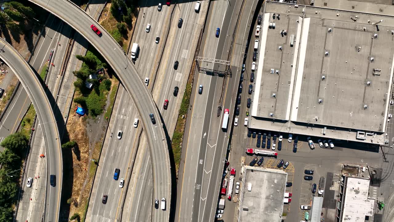 Top down drone shot of cars driving on the freeway through Seattle's Industrial District