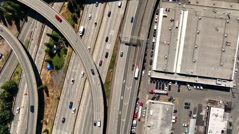 Top down drone shot of cars driving on the freeway through Seattle&#039;s Industrial District