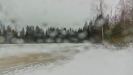 static shot of snow covering ground on a rainy day rural countryside in timelapse