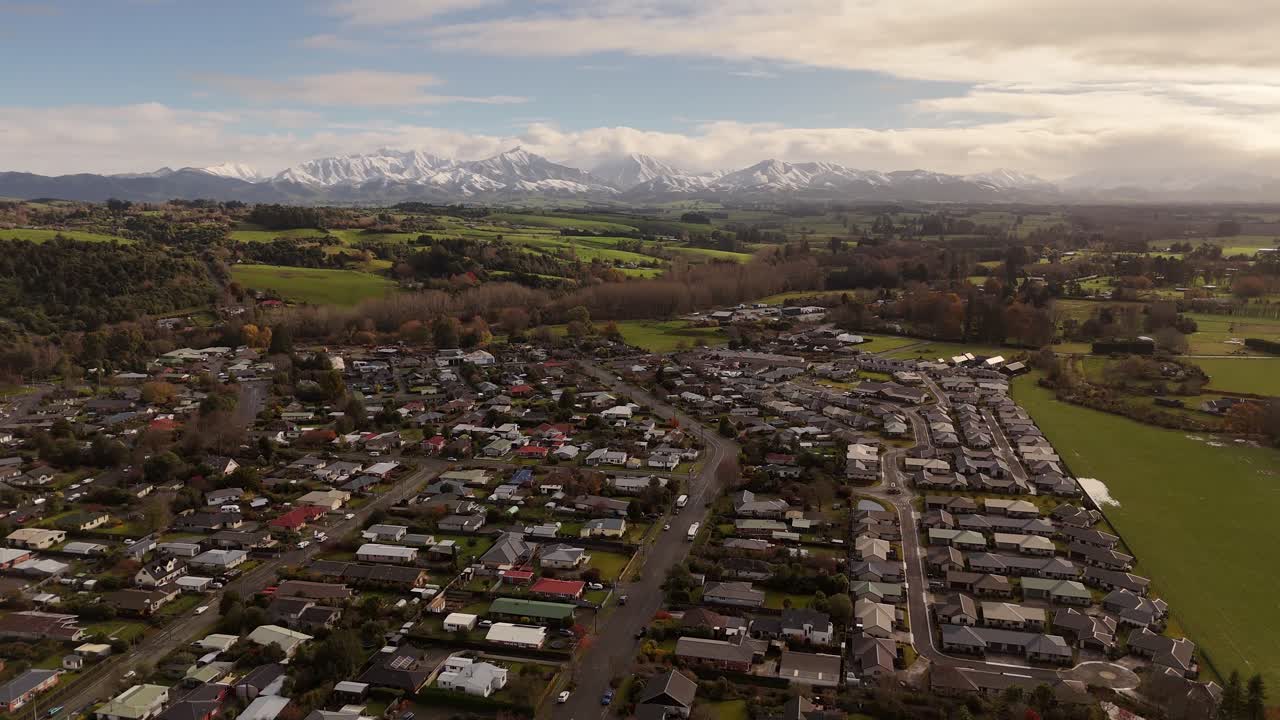 Flying over Geraldine Town, with the snow-capped mountains in the background
