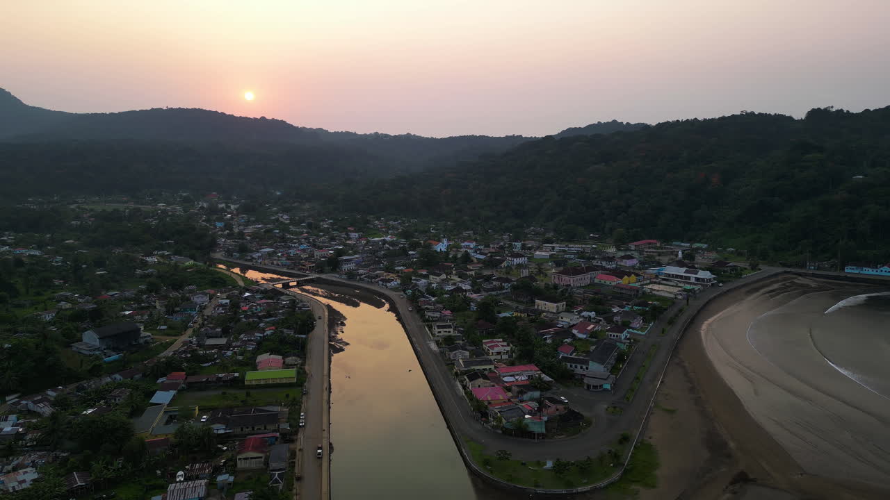 Aerial view backwards over the Santo Antonio city, sunset in Principe, Africa
