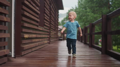 joyful little child runs looking at doors on veranda deck