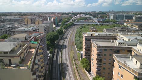 Amazing-Aerial-View-of-Train-Crossing-Under-Ponte-Settimia-Spizzichino-in-Rome,-Italy