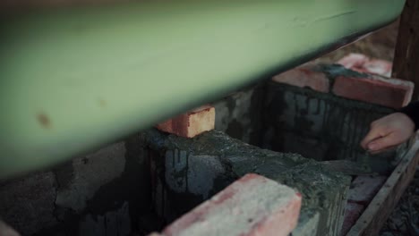 The-Man-is-Spreading-Cement-Onto-the-Concrete-Block-Beneath-the-DIY-Hot-Tub---Close-Up