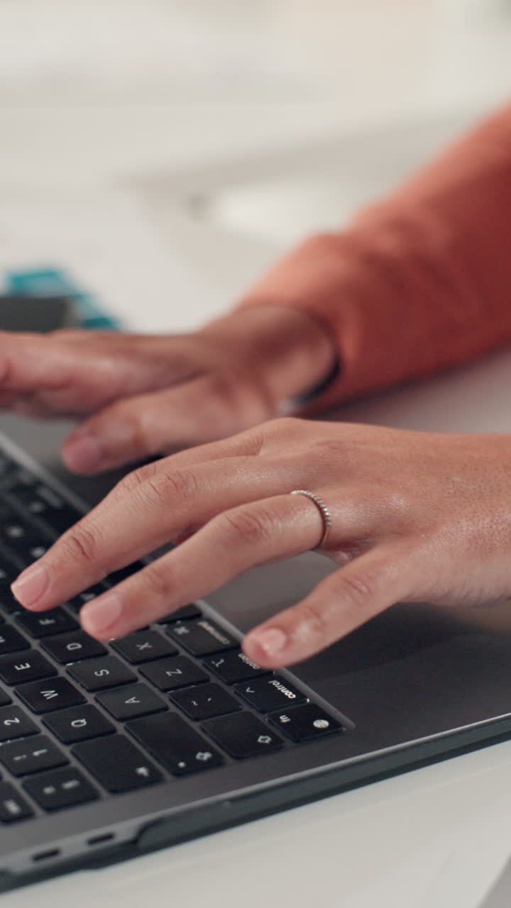 Close-up of Person's Hands Typing on Laptop Keyboard