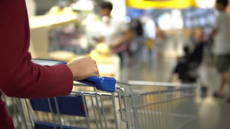 woman pushing shopping cart