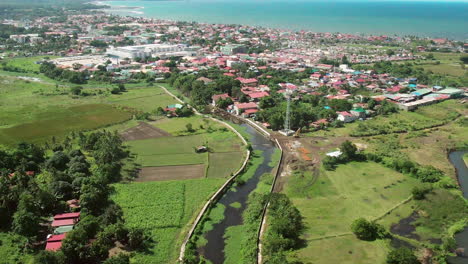 aerial view drone footage of houses and river by the sea with green grass and trees during daytime in 4k quality