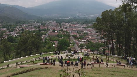 wide aerial footage of the cerro de la cruz that slowly closes in on the cross in antigua, guatemala