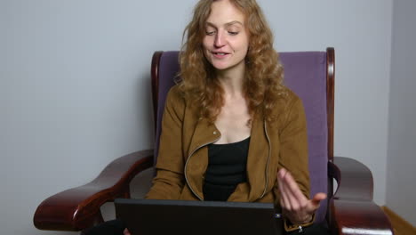 young woman with laptop talk on video call, conference, e-learning concept