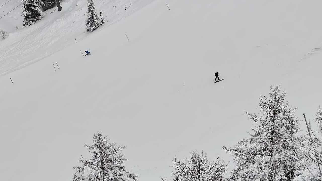 Skiers enjoy winter sports in the Alps of Italy on a snowy day