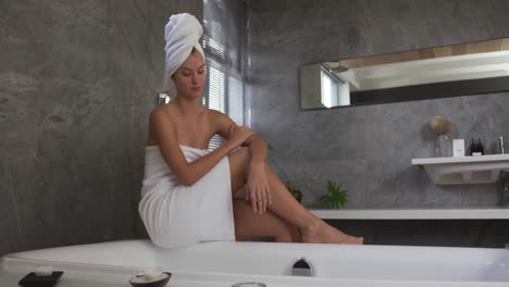 caucasian woman preparing bath in hotel