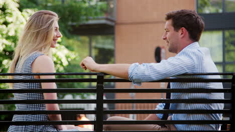 businessman talking to female colleague on break in park