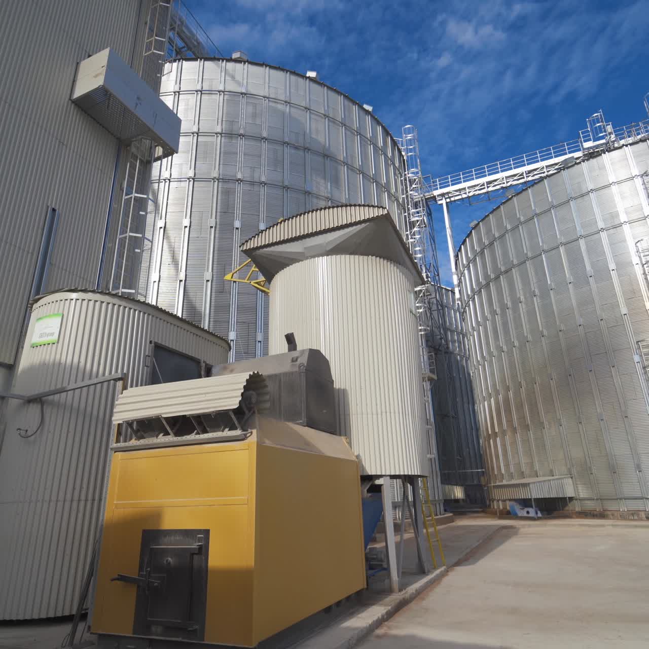 Metal grain elevator in agricultural zone. Grain warehouse