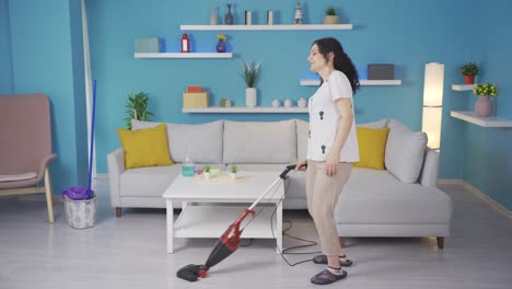 the young woman sweeping the house.