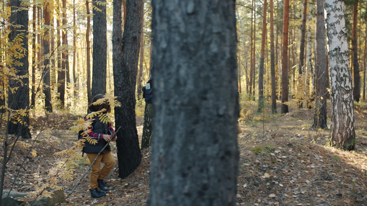 Family Hiking in Autumn Forest