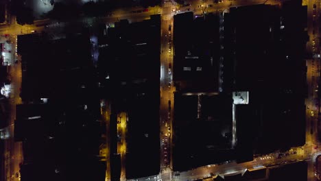 aerial view above night lit streets of sao vicente, brazil - top down, drone shot