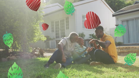 animation of hearts and leaves over african american multi generation men talking in garden