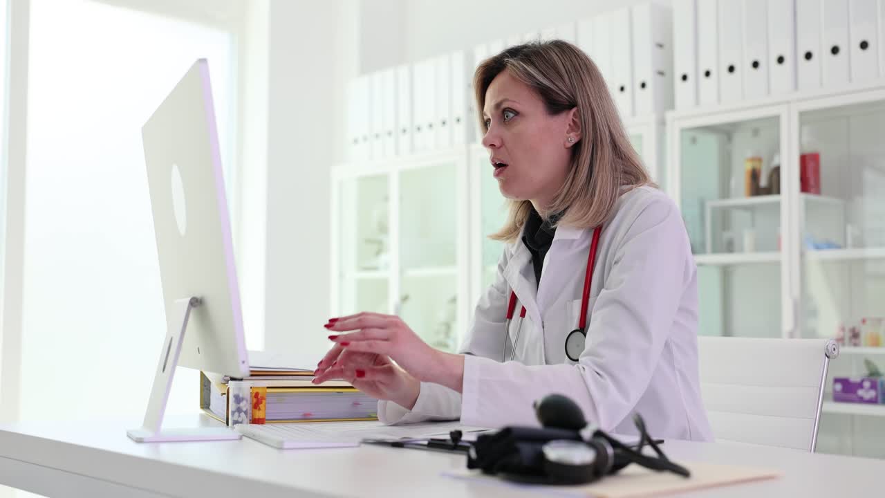 Stressed doctor in front of a computer