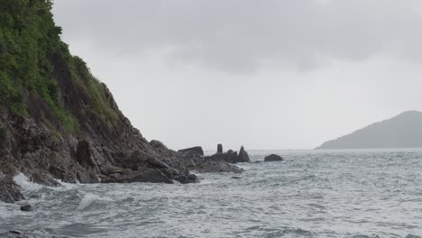 sea waves on the craggy mountains of dam trau beach in con dao island, vietnam