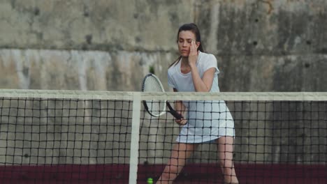 Woman-playing-tennis-on-a-court