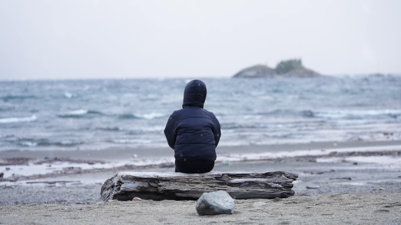 Lonely Person sitting facing Patagonian lake, peaceful solitude and reflection mood, Argentina