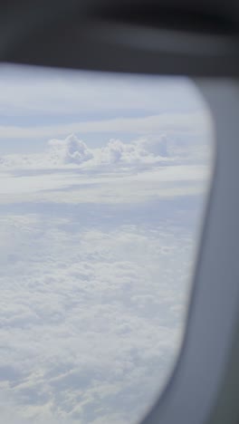sky view from an airplane window, showing clouds