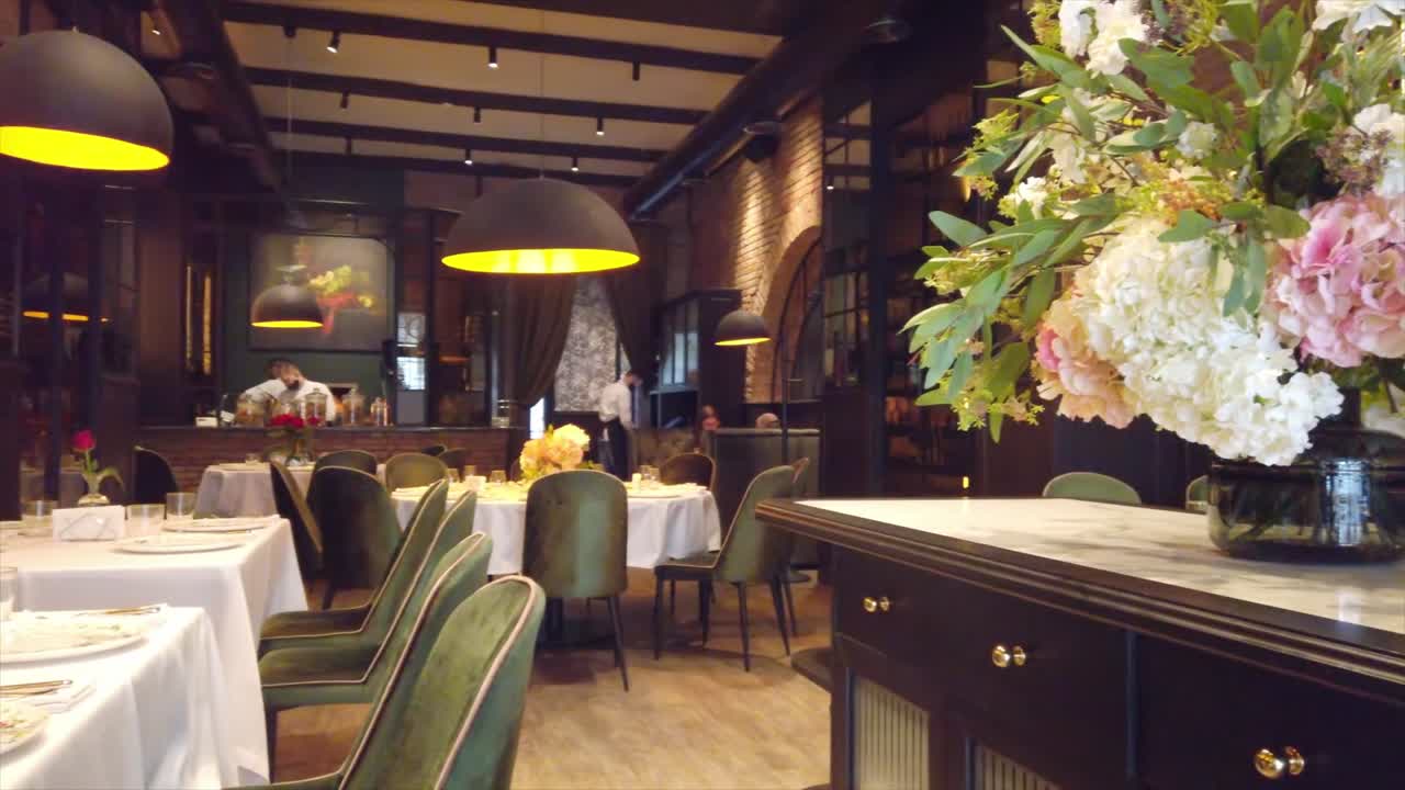 Empty tables with green chairs at a restaurant