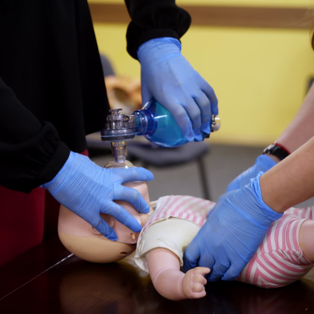 Students practice cpr on a doll. Instructor teaching the proper medical procedure for saving people's life on a dummy